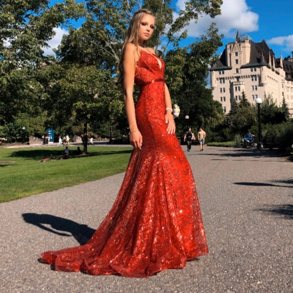 Jovani red sparkly prom dress. Has a long train with a deep v neck.